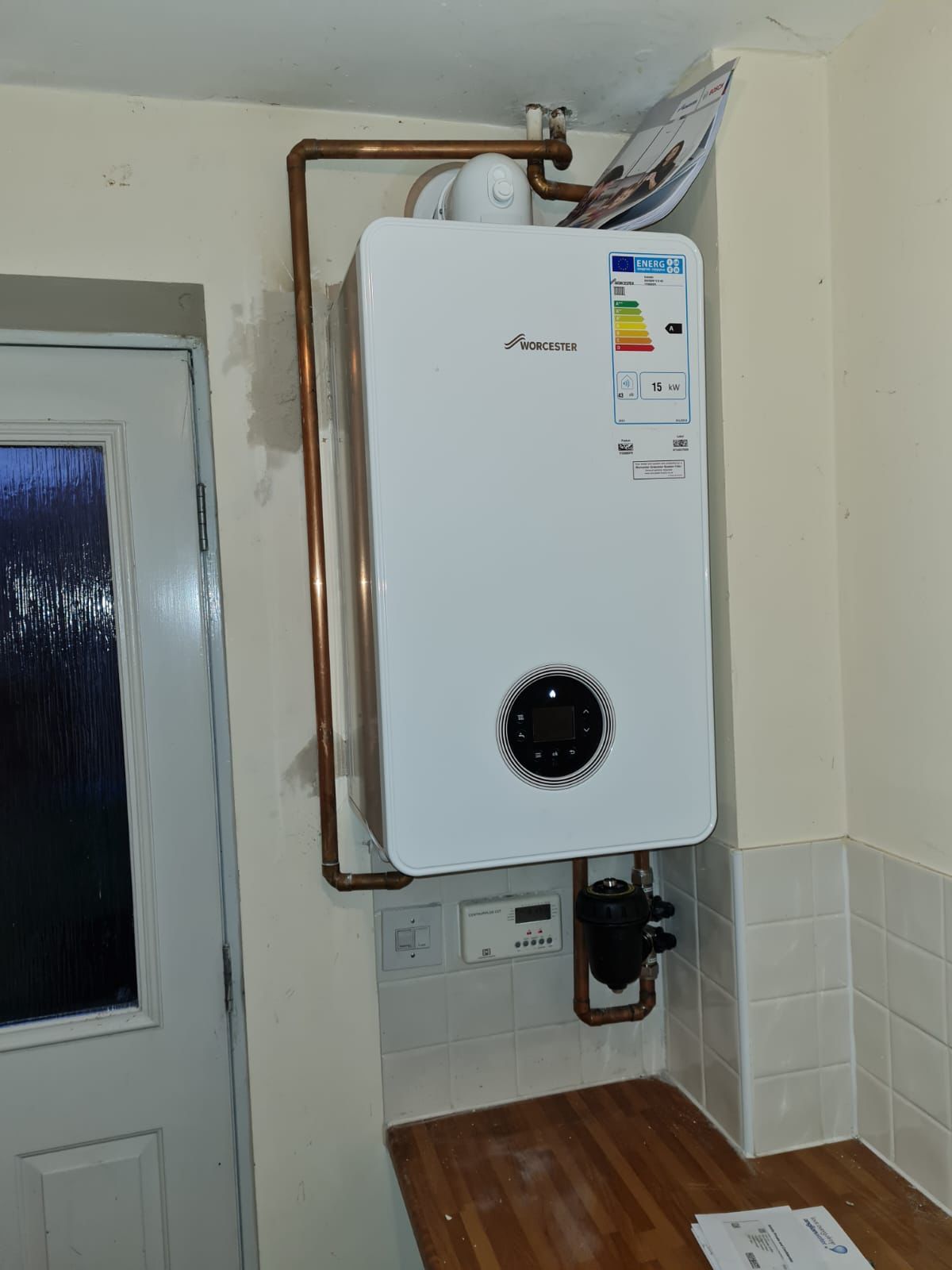 Worcester Bosch combi boiler installed in a Peterborough kitchen with neat copper pipework